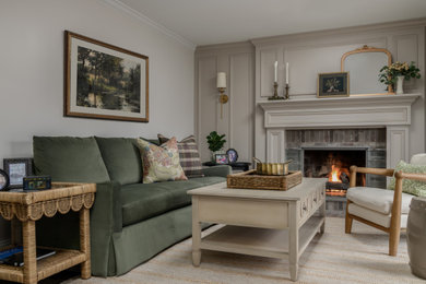 Inspiration for a mid-sized french country open concept dark wood floor and brown floor family room remodel in Philadelphia with beige walls, a standard fireplace and a wood fireplace surround