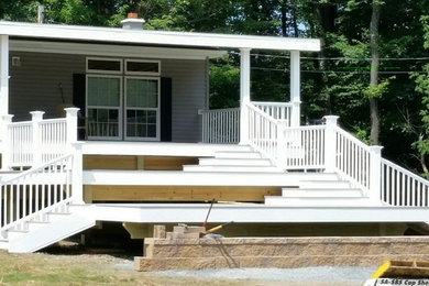 Inspiration for a huge eclectic side yard deck remodel in Other with a roof extension