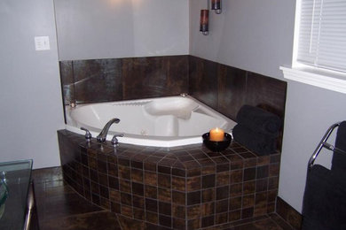 Example of a master brown tile and ceramic tile ceramic tile corner bathtub design in Chicago with white walls