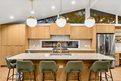 Huge minimalist galley light wood floor and vaulted ceiling eat-in kitchen photo in Dallas with a double-bowl sink, flat-panel cabinets, light wood cabinets, terrazzo countertops, multicolored backsplash, porcelain backsplash, stainless steel appliances, an island and multicolored countertops