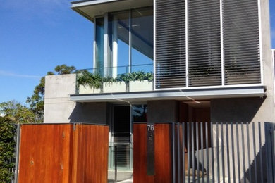 Large modern three-storey concrete grey exterior in Perth with a flat roof.