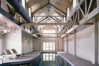 Example of a large country indoor concrete and l-shaped pool house design in Seattle