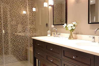 Inspiration for a mid-sized contemporary master beige tile, brown tile, white tile and mosaic tile porcelain tile and beige floor bathroom remodel in Montreal with recessed-panel cabinets, dark wood cabinets, a one-piece toilet, gray walls, an undermount sink, quartz countertops and a hinged shower door