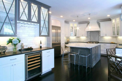 Example of a large transitional u-shaped painted wood floor eat-in kitchen design in Charlotte with a single-bowl sink, recessed-panel cabinets, white cabinets, marble countertops, gray backsplash, subway tile backsplash, stainless steel appliances and an island