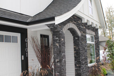 Arts and crafts white two-story stone exterior home photo in Vancouver