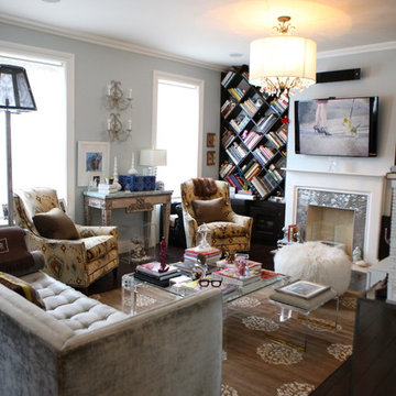 Chic NYC living room; a vintage lucite coffee table, Jonathan Adler slipper gray