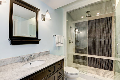 Inspiration for a mid-sized timeless 3/4 white tile and stone tile marble floor alcove shower remodel in DC Metro with furniture-like cabinets, dark wood cabinets, a one-piece toilet, blue walls, a drop-in sink and marble countertops