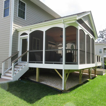 Porch is complete with gable roof and vinyl arched trim