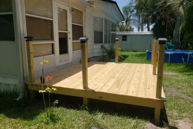 Inspiration for a mid-sized modern backyard ground level mixed material railing deck remodel in Orlando