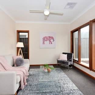 Photo of a contemporary enclosed family room in Adelaide with beige walls, carpet, no tv and grey floor.