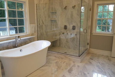 Design ideas for a transitional master bathroom in New York with a freestanding tub, an alcove shower, beige walls and a hinged shower door.