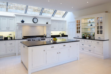 Photo of a contemporary u-shaped open plan kitchen in Other with shaker cabinets, white cabinets and with island.