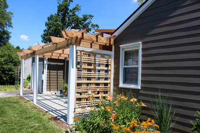 Inspiration for a small timeless brown one-story concrete fiberboard and clapboard exterior home remodel in Philadelphia with a mixed material roof and a brown roof