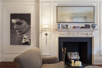 This is an example of a traditional living room in New York with white walls and a standard fireplace.