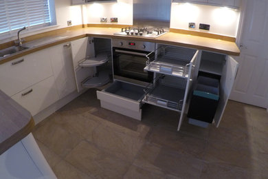 Modern cream gloss kitchen with Oak laminate worktops