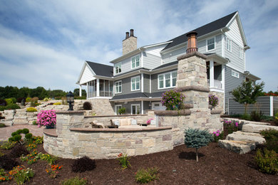 Huge contemporary gray three-story metal exterior home idea in Other with a metal roof