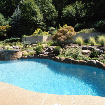 Upper Saucon Township custom built pool with raised spa, waterfall, & boulders