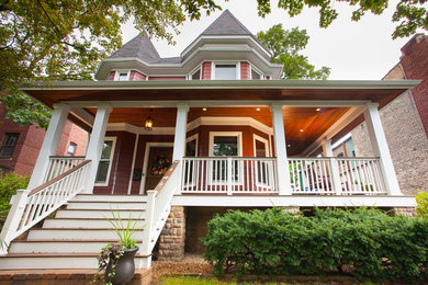 Mid-sized elegant red two-story concrete fiberboard exterior home photo in Chicago