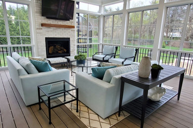 Large transitional screened-in back porch photo in DC Metro with decking and a roof extension
