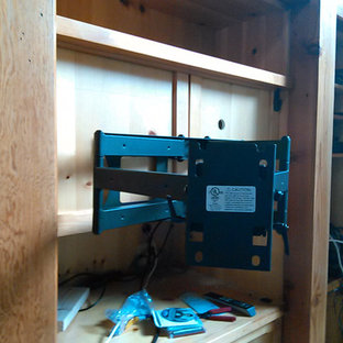 Inspiration for a mid-sized contemporary open concept light wood floor home theater remodel in Manchester with blue walls and a wall-mounted tv