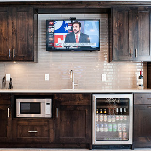 ミネアポリスの中サイズのトラディショナルスタイルのおしゃれなウェットバー (アンダーカウンターシンク、シェーカースタイル扉のキャビネット、濃色木目調キャビネット、珪岩カウンター、グレーのキッチンパネル、サブウェイタイルのキッチンパネル、クッションフロア) の写真