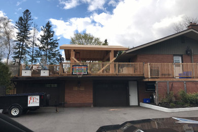 Inspiration for a large modern rooftop rooftop wood railing outdoor kitchen deck remodel in Other with a pergola