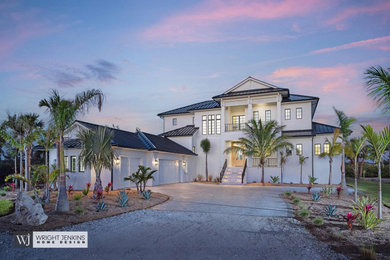 Mid-sized minimalist white two-story mixed siding and clapboard house exterior photo in Tampa with a hip roof, a metal roof and a gray roof