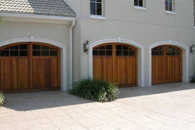 Inspiration for a large craftsman attached three-car garage remodel
