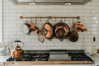 Example of a mountain style kitchen design in New York with white backsplash, white appliances and white countertops