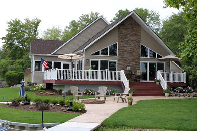 Large trendy beige one-story mixed siding exterior home photo in Detroit