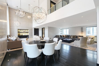 This is an example of a large contemporary dining room in London with dark hardwood floors.