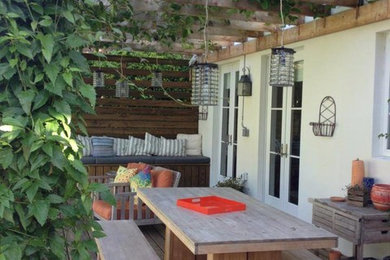 Mid-sized mountain style backyard deck photo in Miami with a pergola