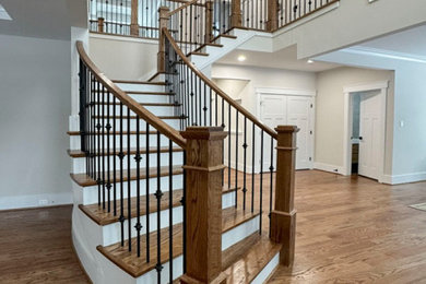 Inspiration for a mid-sized transitional wooden curved mixed material railing staircase remodel in DC Metro with wooden risers