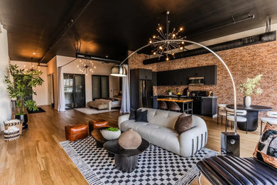 Inspiration for a large contemporary medium tone wood floor and brown floor living room remodel in Other with white walls