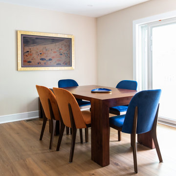 Eclectic Dining Room with Velvet Chairs and Warm Wood Table
