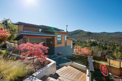 Modern multicolored three-story mixed siding house exterior idea in Other with a metal roof