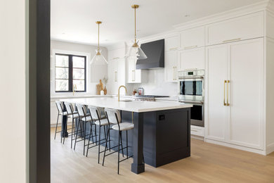 Large transitional galley light wood floor and beige floor eat-in kitchen photo in Toronto with a single-bowl sink, shaker cabinets, white cabinets, quartz countertops, white backsplash, quartz backsplash, paneled appliances, an island and white countertops