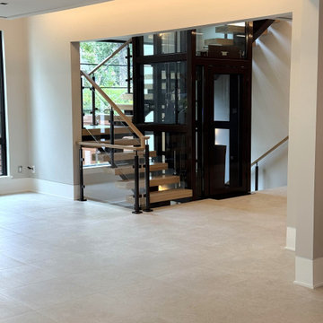 Project #136 | Modern Floating Staircase Encircling Glass Elevator
