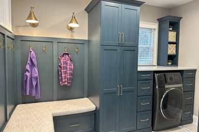 Inspiration for a mid-sized transitional l-shaped ceramic tile and beige floor utility room remodel in Cincinnati with blue cabinets, quartz countertops, beige walls and white countertops