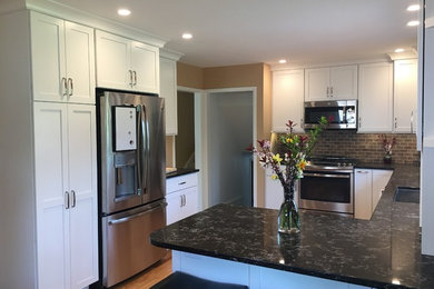 Example of a transitional kitchen design in Cedar Rapids with shaker cabinets, white cabinets and quartz countertops