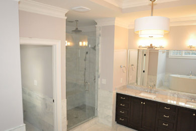 Example of a large transitional master gray tile, white tile and marble tile marble floor and gray floor alcove shower design in Atlanta with shaker cabinets, dark wood cabinets, beige walls, an undermount sink, marble countertops and a hinged shower door