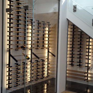 Southlake glass and metal racking under stairs cellar