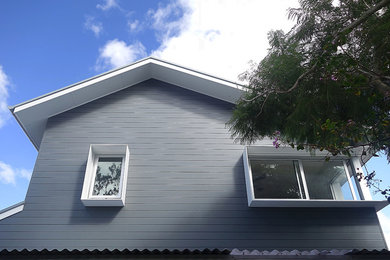 This is an example of a contemporary two-storey grey exterior in Sydney with a gable roof.
