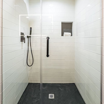 Walk-In Shower with Vertical White Tile and Black Fixtures
