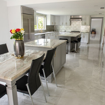Transitional Kitchen Done in a 2 Tone Color With Integrated Dining Table
