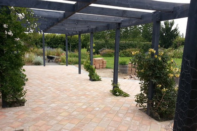 Inspiration for a traditional patio in Christchurch with concrete pavers.