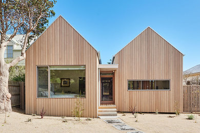 Inspiration for a mid-sized beach style front door in Geelong with grey walls, light hardwood floors, a single front door, a medium wood front door and beige floor.