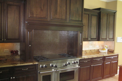 Mid-sized transitional l-shaped ceramic tile open concept kitchen photo in Chicago with an island, raised-panel cabinets, dark wood cabinets, beige backsplash, subway tile backsplash and stainless steel appliances