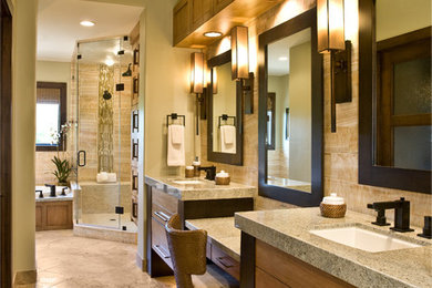 Large trendy master multicolored tile and stone tile marble floor corner shower photo in Salt Lake City with an undermount sink, flat-panel cabinets, medium tone wood cabinets, granite countertops, an undermount tub, a one-piece toilet and beige walls