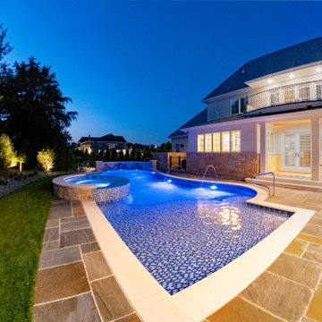 Naperville, IL freeform swimming pool with hot tub, large sunshelf, glass tile